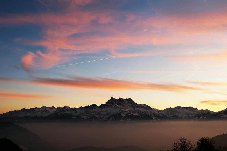 the sun is setting over a mountain range, by Karl Stauffer-Bern, pexels contest winner, romanticism, pink clouds, conde nast traveler photo