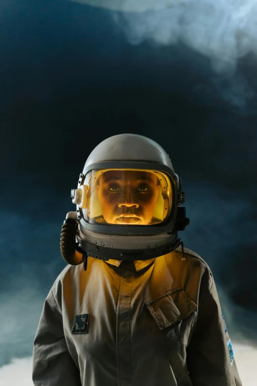 a man in a space suit standing in front of a cloudy sky, pexels contest winner, afrofuturism, portrait of cute pilot girl, in front of dark smoke, award winning movie still, curious expression