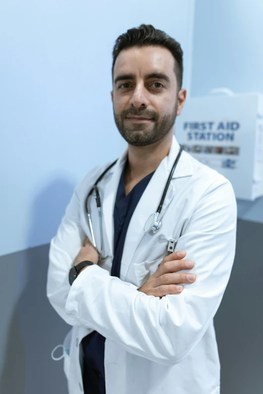 a man in a white lab coat standing with his arms crossed, a picture, by Adam Marczyński, farid ghanbari, promo image, emergency room, riccardo federici