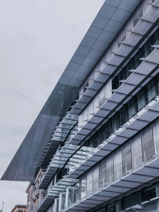 a very tall building with a lot of windows, inspired by Tadao Ando, unsplash, grey, low quality photo, close - up profile, morphosis