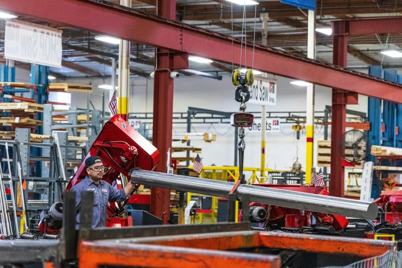 a man working on a machine in a factory, red trusses, fan favorite, jpl, steel pipes