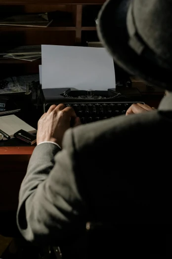 a man sitting at a desk typing on a laptop, by Jesper Knudsen, unsplash, private press, dressed like in the 1940s, mystery and detective themed, thumbnail, digital image