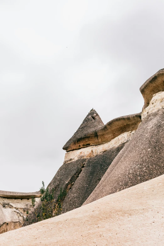 a man riding a skateboard on top of a sandy hill, an album cover, trending on unsplash, les nabis, giant tomb structures, southern slav features, panorama, trulli