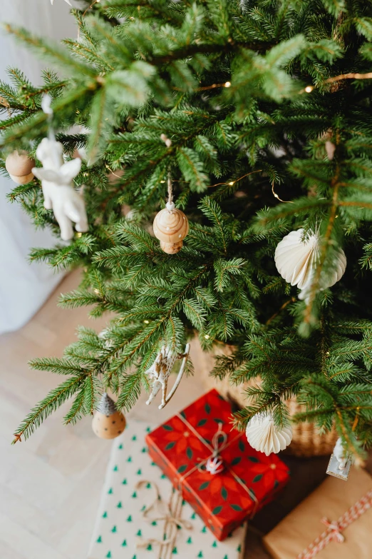 a christmas tree with presents underneath it, organic ornaments, zoomed in, pine, medium details