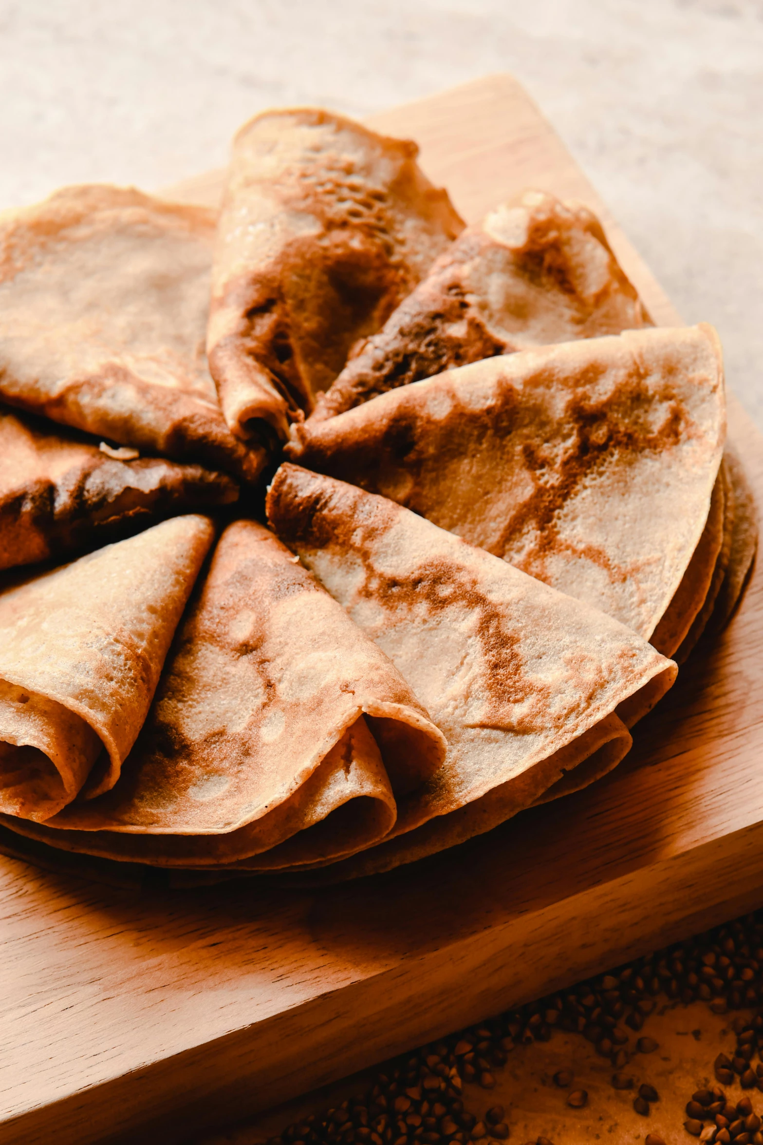 a wooden cutting board topped with tortillas on top of a table, inspired by Géza Dósa, renaissance, dessert, thumbnail, crispy, ethiopian