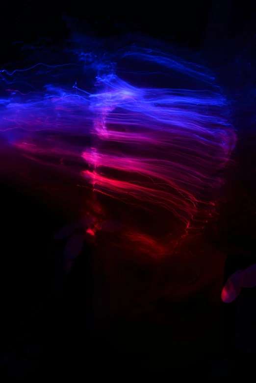 a blurry photo of a person in the dark, unsplash, light and space, red and blue black light, flowing rhythms, jelly - like texture, streamers