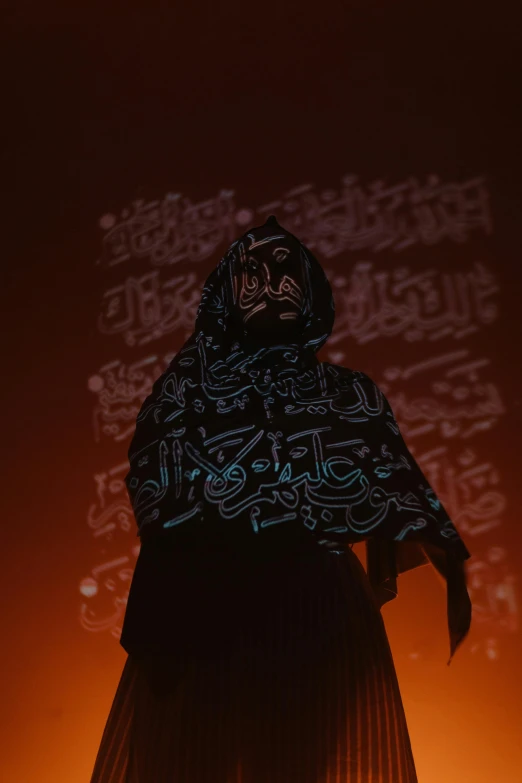 a person standing in front of a wall with writing projected on it, by Kamāl ud-Dīn Behzād, holography, wearing hoods, silhoutte, covered in runes, high quality photo