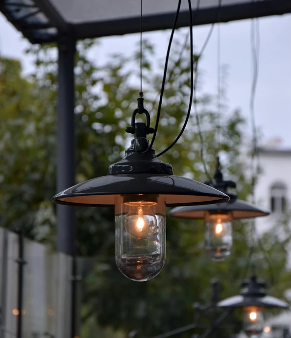 a couple of lights hanging from the side of a building, al fresco, dieselpunk setting, trending photo, closeup - view