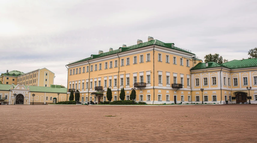 a large yellow building with a green roof, inspired by Illarion Pryanishnikov, neoclassicism, royal palace, whitewashed buildings, ground - level view, russia in 2 0 2 1