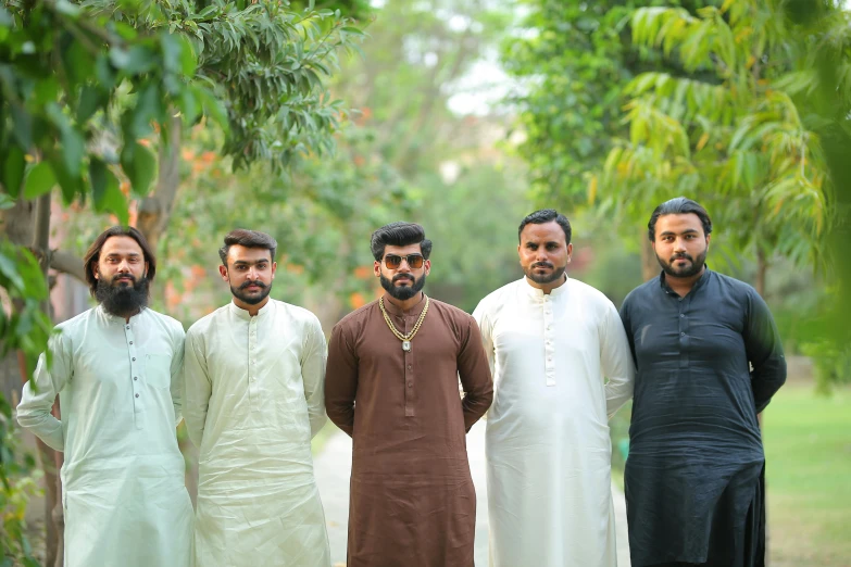 a group of men standing next to each other, by Riza Abbasi, pexels contest winner, hurufiyya, wearing a kurta, al fresco, ( ( theatrical ) ), without beard