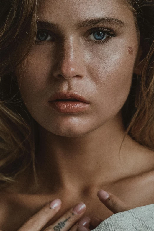 a close up of a woman with a ring on her finger, a photorealistic painting, inspired by Elsa Bleda, trending on pexels, hyperrealism, big cheekbones, model with attractive body, cinematic jennifer lawrence, more tan face