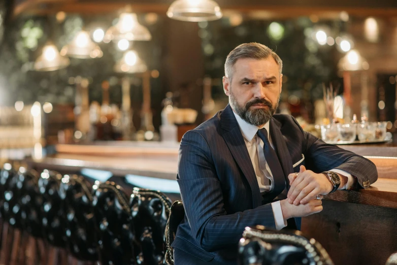 a man in a suit sitting at a bar, a portrait, by Alexander Fedosav, pexels contest winner, renaissance, very attractive man with beard, 40 years old women, thumbnail, avatar image