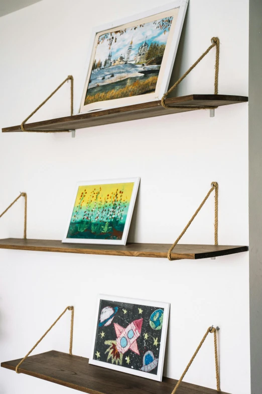 a couple of shelves that have pictures on them, unsplash, temporary art, hanging rope, ecommerce photograph, ballard, 24k