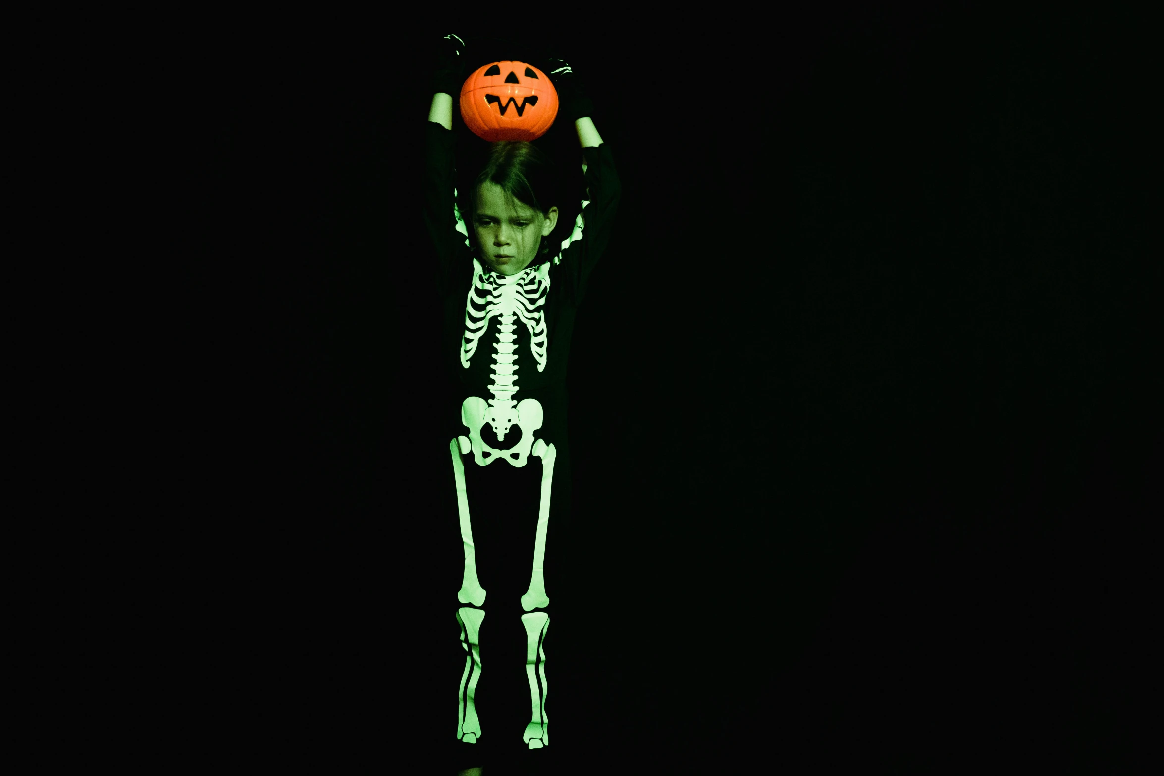 a skeleton with a pumpkin on his head, a hologram, pexels, slender boy with a pale, full - length photo, luminescent, photographed for reuters