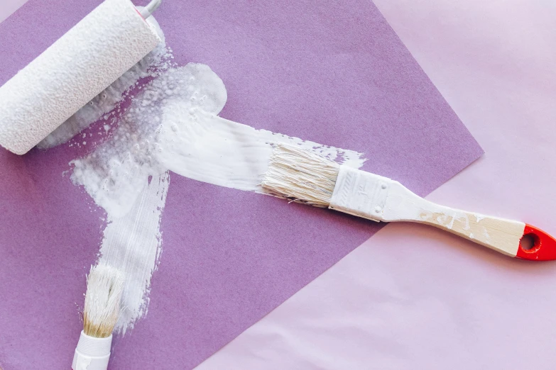 a paint roller sitting on top of a piece of paper, inspired by Julian Schnabel, trending on pexels, lavender blush, holding paintbrushes, white furniture, second colours - purple