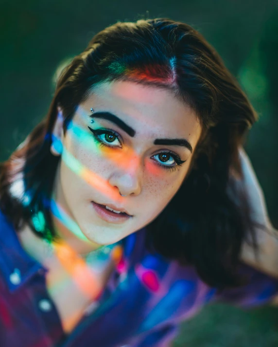 a woman with a rainbow light on her face, inspired by Elsa Bleda, trending on pexels, charli xcx, androgynous male, pov photo, attractive photo