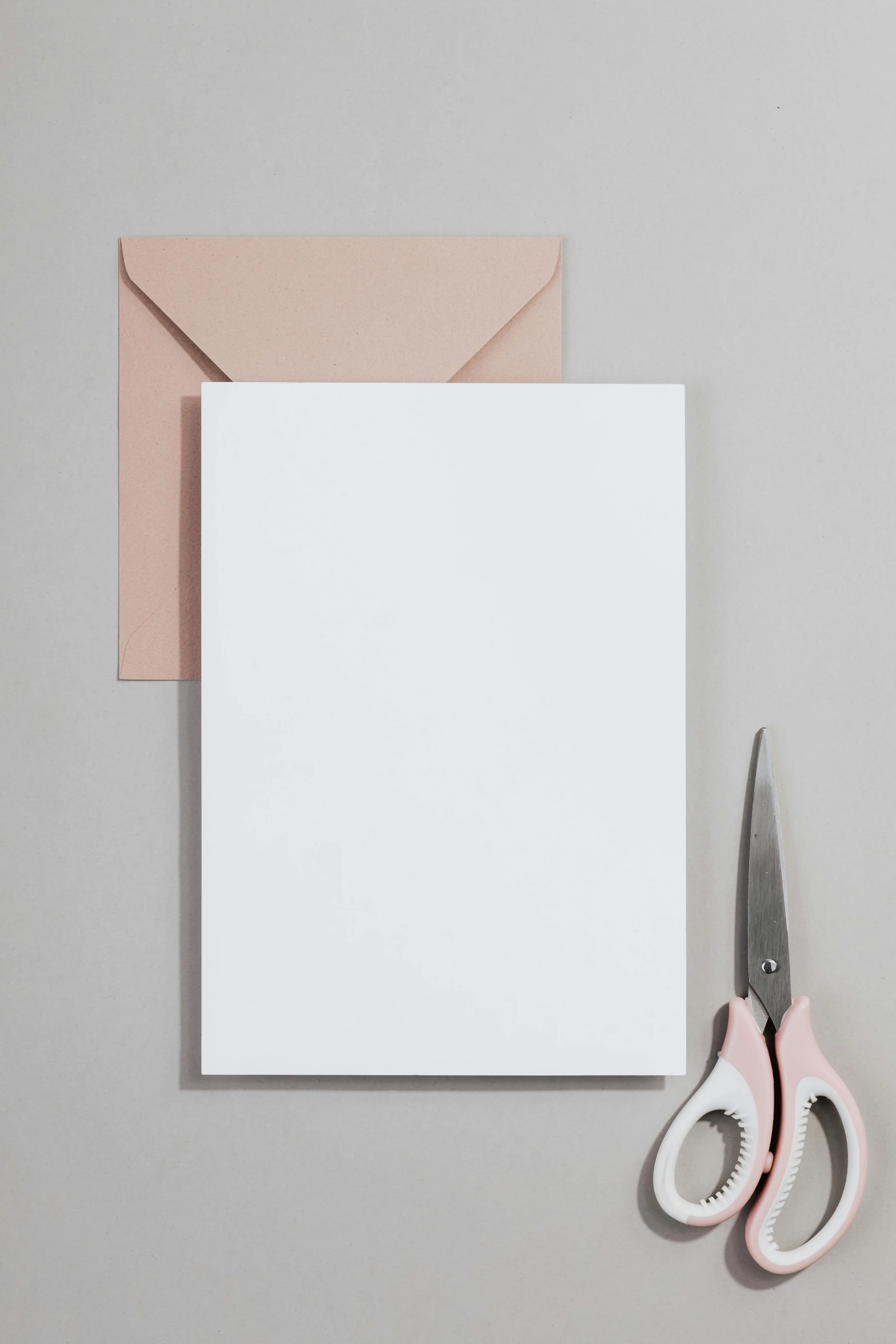 a pair of scissors sitting next to a piece of paper, blush, rectangle, large vertical blank spaces, greeting card