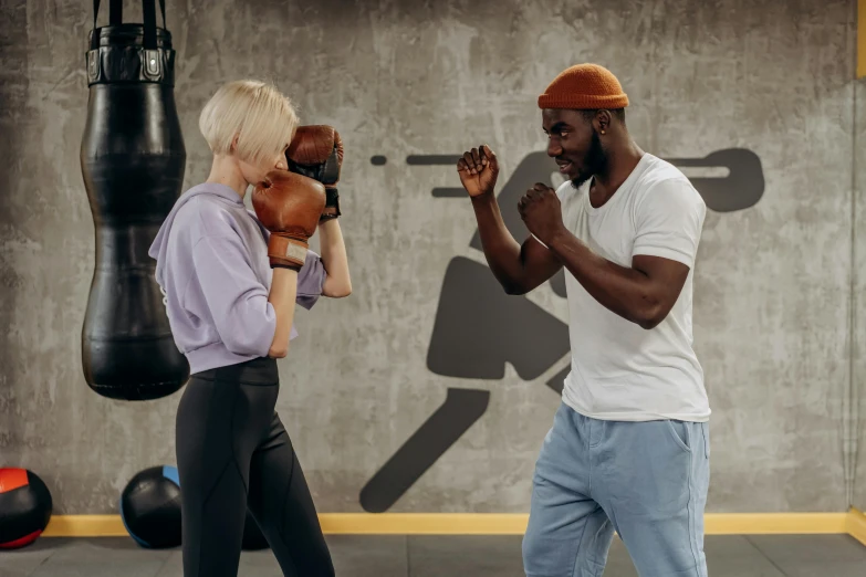 a man and a woman boxing in a gym, pexels contest winner, charli bowater and artgeem, brown, thumbnail, lower quality