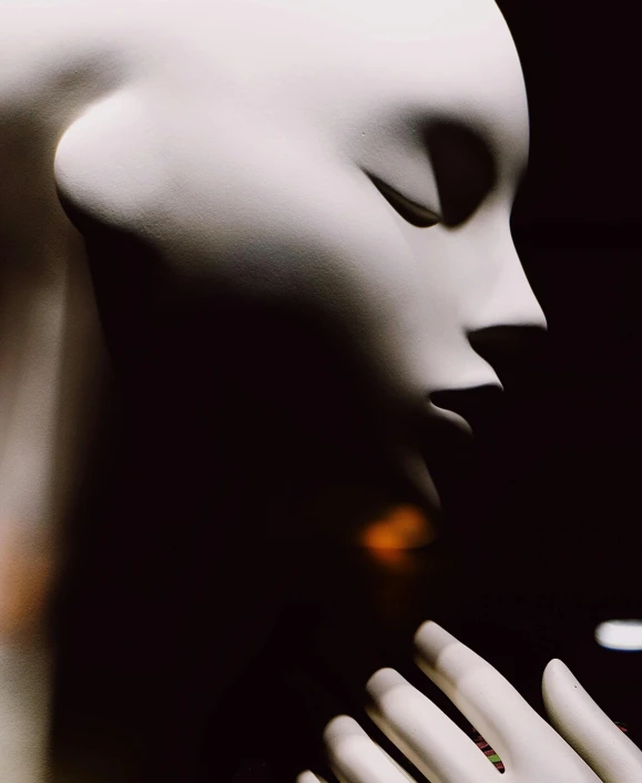 a close up of a mannequin holding a cell phone, by David Donaldson, pexels contest winner, figurative art, glowing mouth, thin porcelain, dreamy and ethereal and dark, the kiss