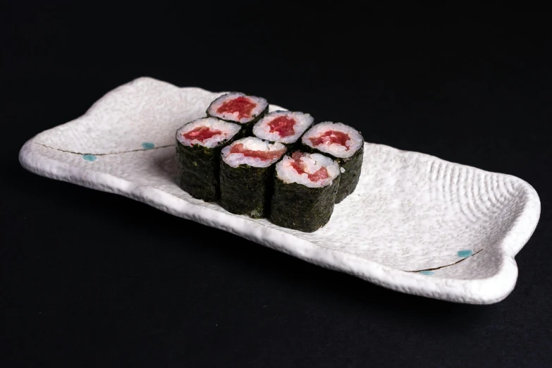 a close up of a plate of food on a table, sushi, detailed product image, red emerald, 6 pack