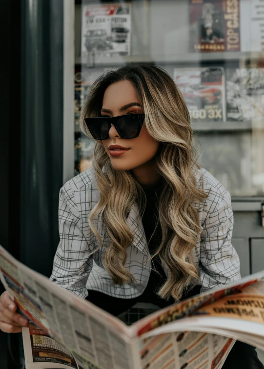 a woman sitting on a bench reading a newspaper, by Julia Pishtar, trending on pexels, glam hair, with sunglass, long ashy hair, kailee mandel