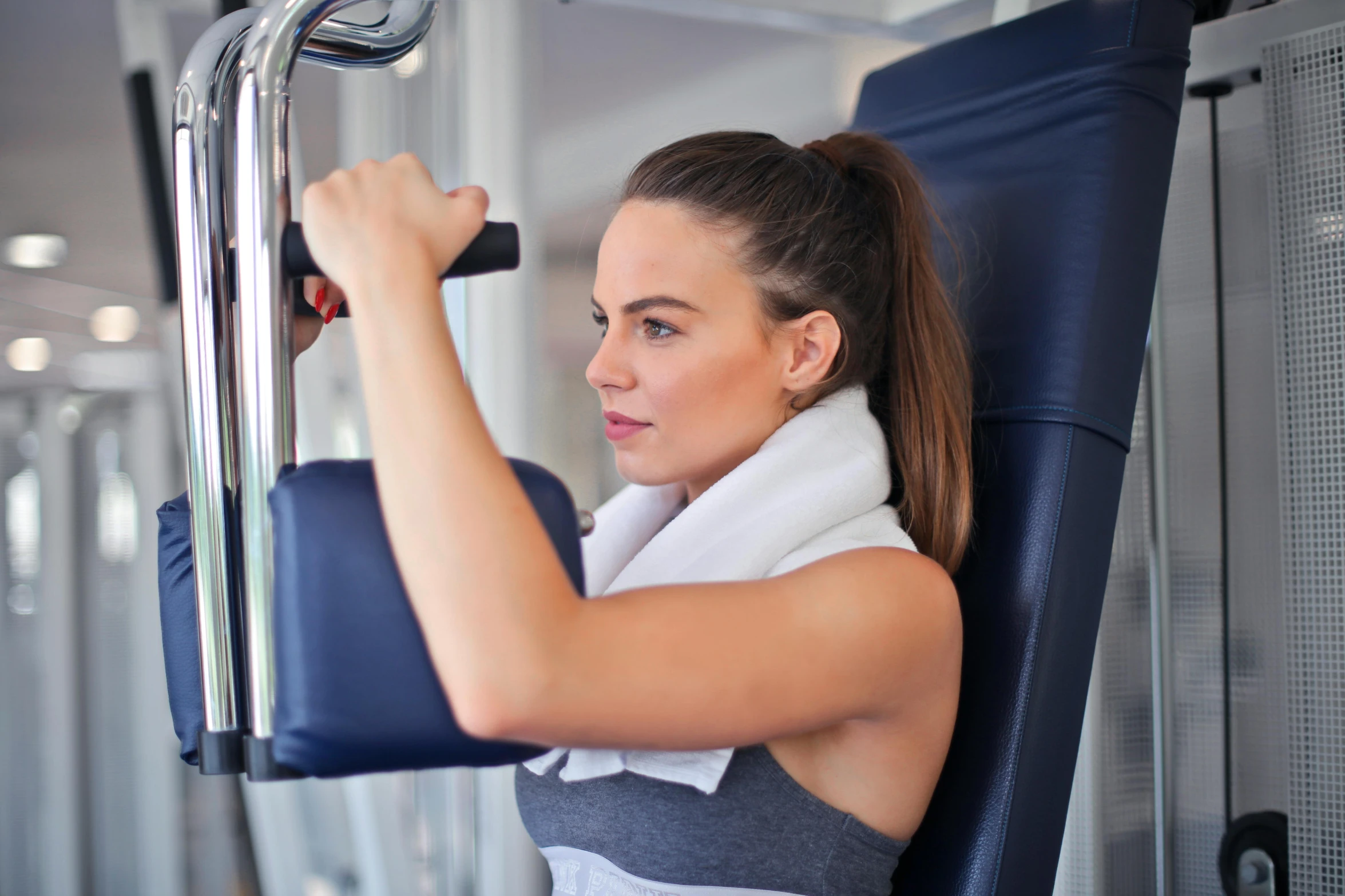 a woman working out on a machine in a gym, private press, lachlan bailey, bashful expression, local gym, profile image