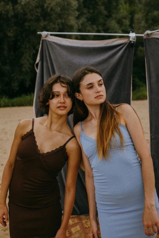 two women standing next to each other on a beach, by Attila Meszlenyi, trending on pexels, renaissance, wearing a camisole, subdued colors, portrait sophie mudd, promotional image