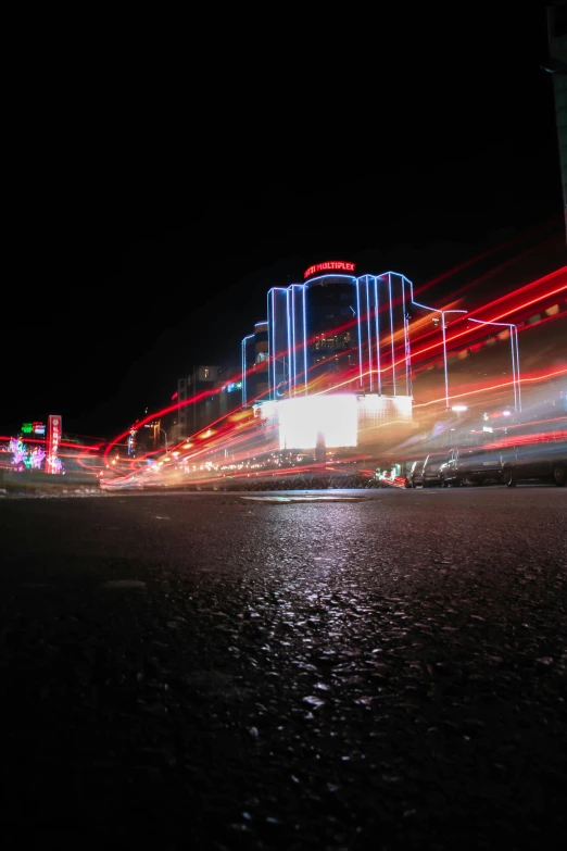 a city street filled with lots of traffic at night, lightshow, red and white neon, speed lines, downtown mexico