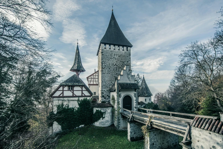 a castle sitting on top of a lush green hillside, an album cover, by Thomas Häfner, pexels contest winner, romanesque, elegant bridges between towers, winter, romanian heritage, samorost