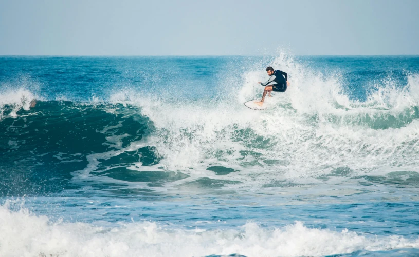 a man riding a wave on top of a surfboard, pexels contest winner, figuration libre, bali, thumbnail, cr3, performing