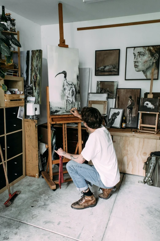 a man sitting on a stool in front of a painting, pexels contest winner, tending on art station, profile picture, canvas art print, lachlan bailey