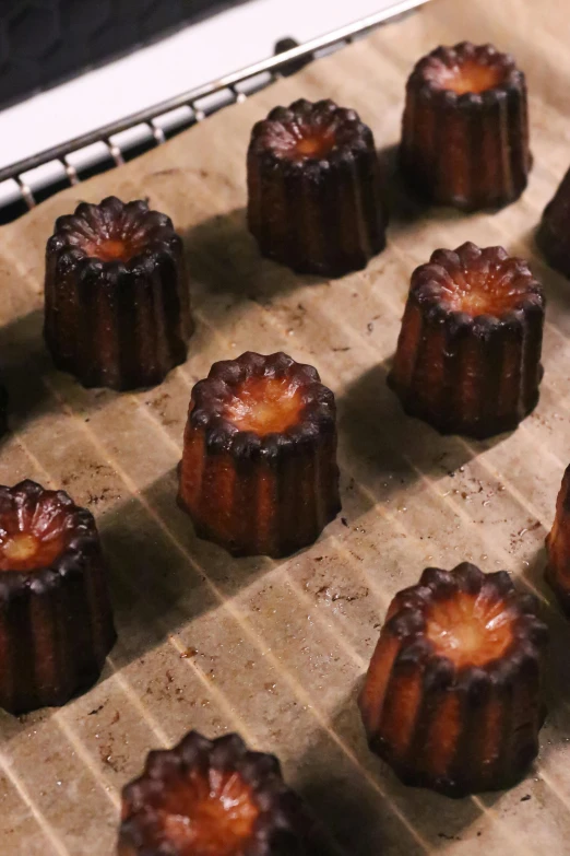 a pan filled with pastries sitting on top of a table, inspired by Charles Le Roux, reddit, baroque, many cryogenic pods, coated pleats, hand carved brown resin, video