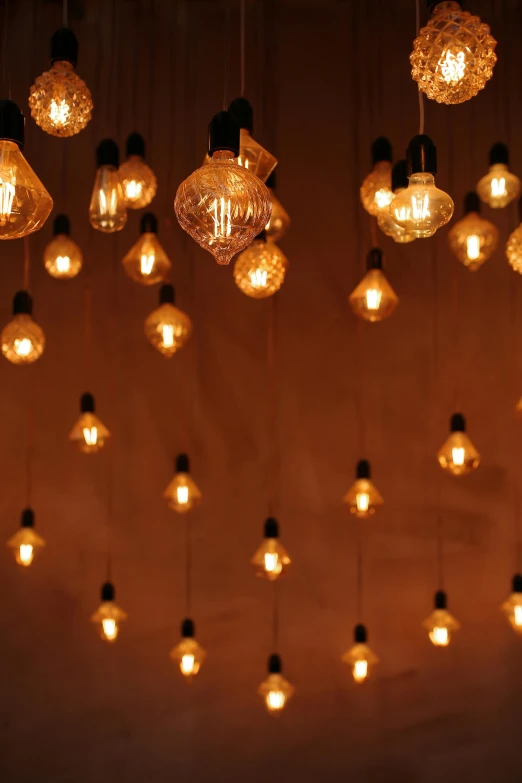 a bunch of light bulbs hanging from the ceiling, inspired by Elsa Bleda, pexels, light and space, ambient amber light, dynamic lighting, festive atmosphere, taken in the late 2010s