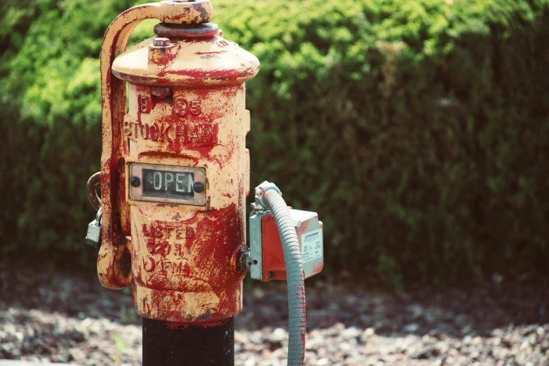 a rusty fire hydrant sitting on the side of a road, an album cover, unsplash, auto-destructive art, letterbox, retro effect, maintenance photo, purpose is pump