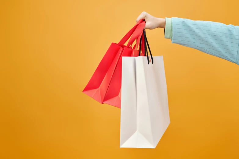 a person holding shopping bags against a yellow background, by Julia Pishtar, square, without text, guide, thumbnail