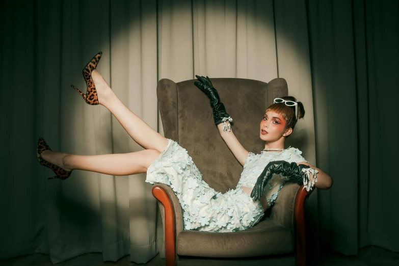 a woman in a white dress is sitting in a chair, inspired by Elsa Bleda, pexels contest winner, kitsch movement, doing a sassy pose, sophia lillis, high heels and gloves. motion, patterned clothing