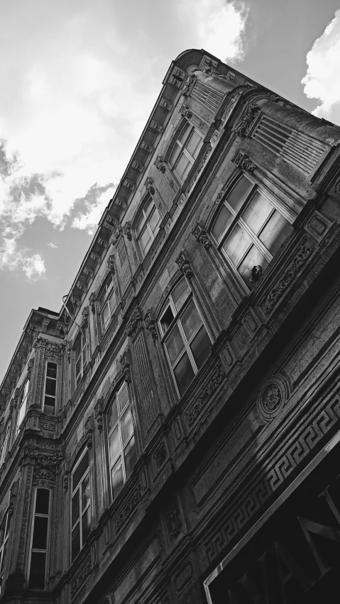 a black and white photo of a tall building, a black and white photo, arabesque, victorian buildings, low angle photograph, square, portait photo