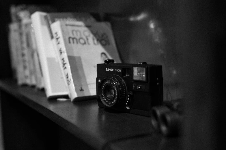 a black and white photo of a camera on a shelf, a black and white photo, by Mathias Kollros, a portrait of @hypnos_onc, konica minolta, ((sharp focus)), medium format