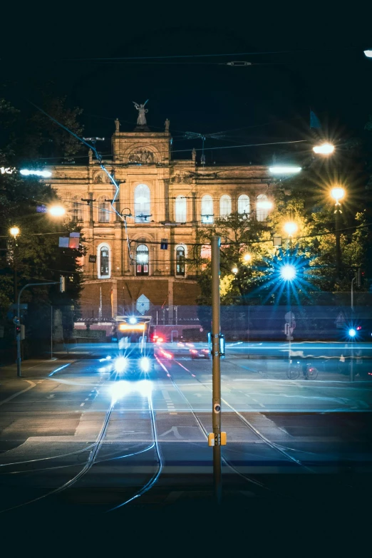 a city street filled with lots of traffic at night, by Adam Marczyński, unsplash contest winner, neoclassical police station, north melbourne street, parliament, historical photo