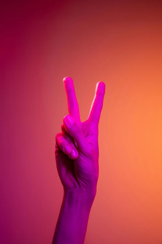 a person's hand holding up a peace sign, pexels contest winner, purple orange colors, his one yes glow red, two horns, 2022 photograph