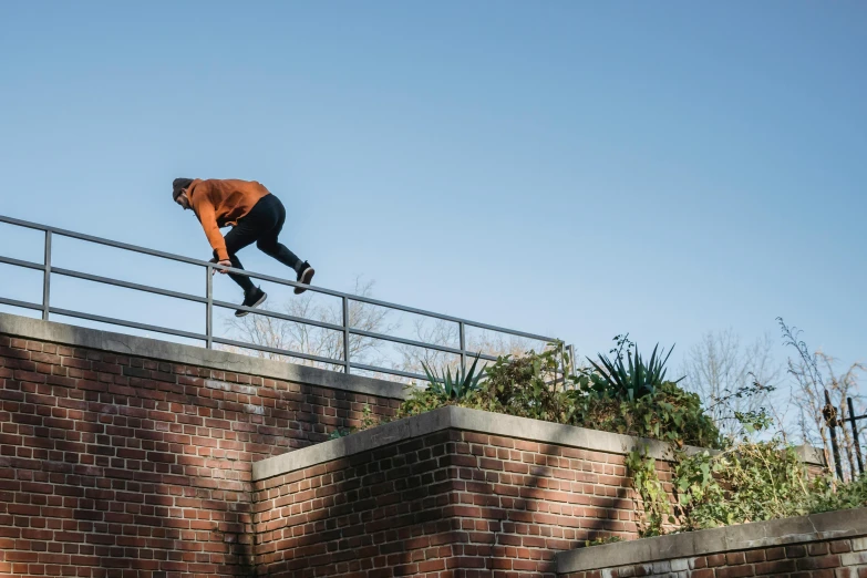 a man flying through the air while riding a skateboard, by Jan Tengnagel, unsplash, happening, railing, bricks flying, low quality photo, dutch angle