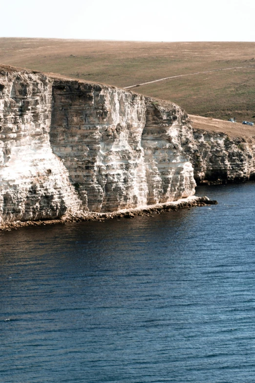 a large body of water next to a cliff, les nabis, black sea, slide show, close - up photo, marsden