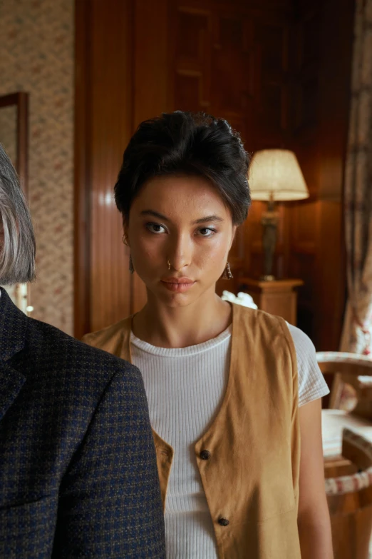 a man and a woman standing next to each other, inspired by Min Zhen, woman's face looking off camera, cinestill colour, indoor scene, beautiful surroundings