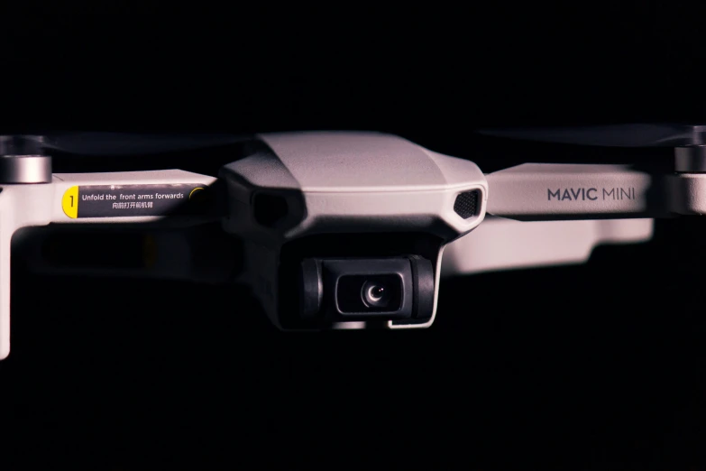 a close up of a white drone on a black background, by Matt Cavotta, maya 8 k, maven, secuirty cam footage, oled visor for eyes