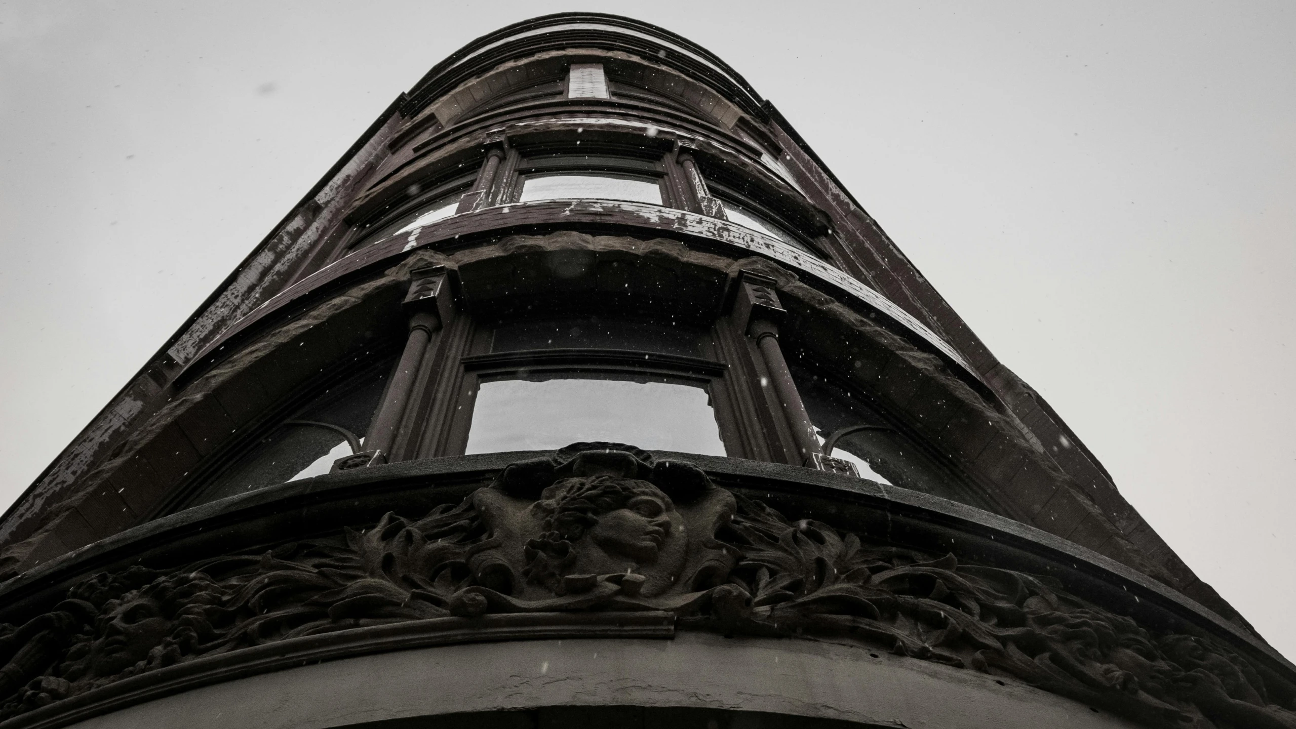 a black and white photo of a tall building, a black and white photo, pexels contest winner, art nouveau, bay window, faded worn, looking downwards, high details photo