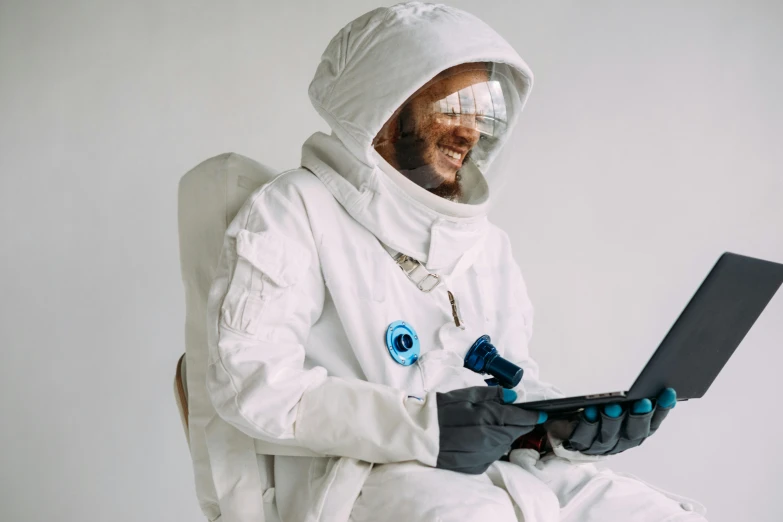 a man in an astronaut suit using a laptop, inspired by Alan Bean, pexels contest winner, afrofuturism, dressed in an old white coat, white space, instagram picture, cinematic outfit photo