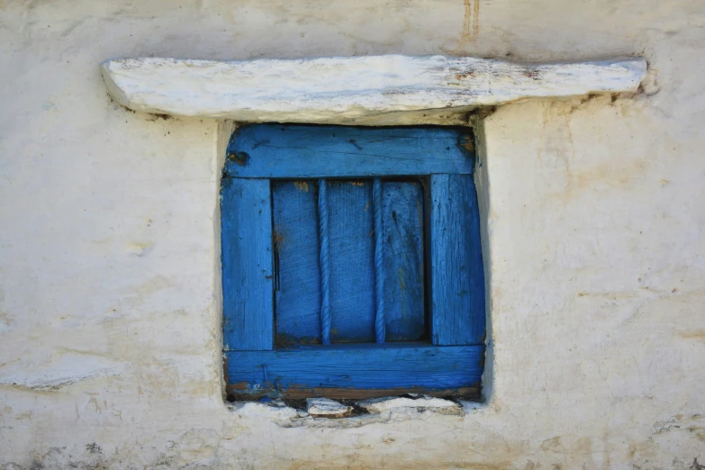 a blue window on the side of a white building, inspired by William Nicholson, pexels contest winner, cyprus, shack close up, neo-andean architecture, outworldly colours