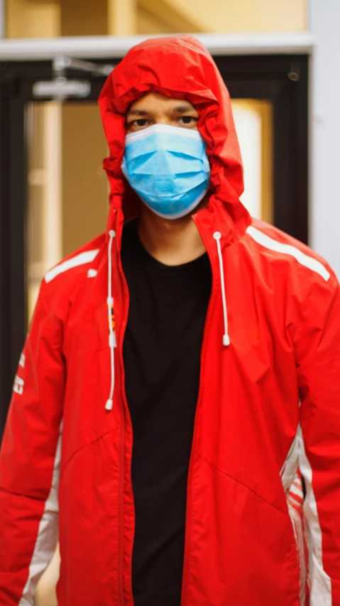 a man in a red jacket and a face mask, hospital, trending on r/streetwear, 15081959 21121991 01012000 4k, promo image