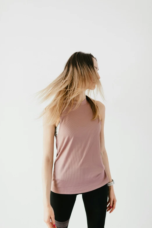 a woman in a pink tank top and black leggings, trending on unsplash, muted colors. ue 5, flowy hair, half body photo, sleeveless turtleneck