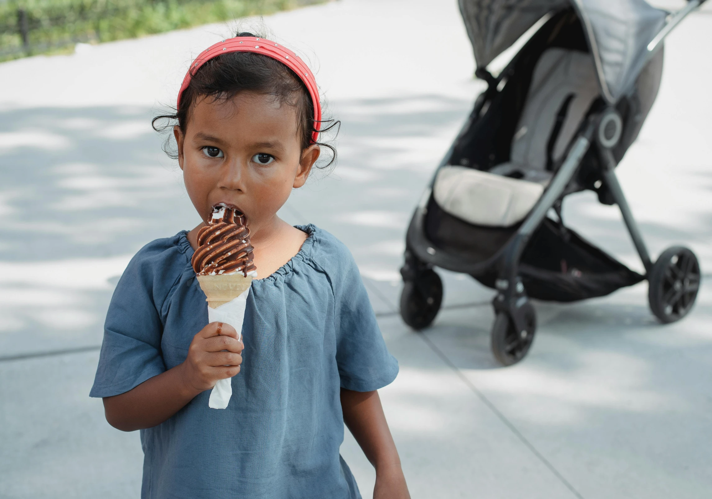 a little girl eating an ice cream cone, by Nina Hamnett, pexels contest winner, black, fully chocolate, standing with a parasol, rectangle